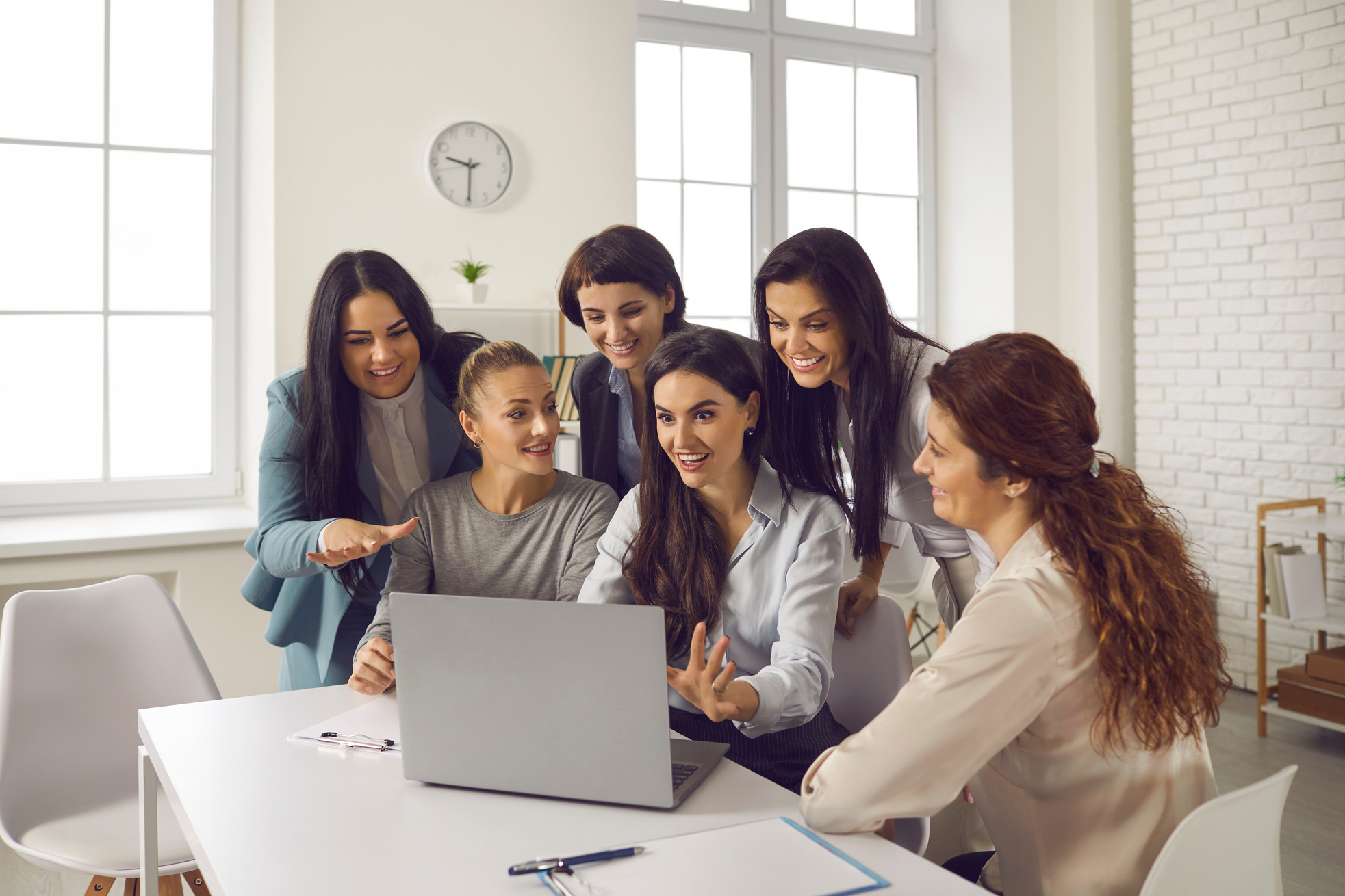 Group of Happy Smiling Young Businesswomen Having Video Call with Their Colleagues